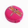 Beaded dragonfly brooch on bright pink velvet ring box, handcrafted jewelry, colorful accessory for women, jewelry gift idea, intricate beadwork design.