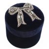 Elegant rhinestone bow brooch on velvet jewelry box, perfect for accessorizing and gift-giving.