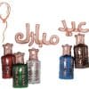 Colorful balloon letters spelling "JUL" with decorative candle bottles in red, green, white, blue, and brown, perfect for a festive celebration or birthday party setup.