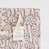 Vibrant pink floral printed gift bag with black outlines, crafted from recycled cotton paper, perfect for eco-friendly packaging and gift presentation.