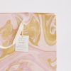 Vibrant handmade marbled gift bag in pink and gold tones, featuring a reusable cotton handle and a delicate paper tag. Perfect for eco-friendly gifting with artistic, artisanal craftsmanship.