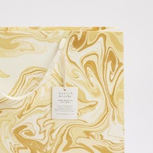 Elegant marbled gift bag with gold and cream swirls, perfect for packaging and presentation at The Wraperie. Handcrafted using eco-friendly, recycled paper for sustainable gifting.