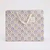 Vibrant gift box with purple floral design and cotton ribbon handle, perfect for wrapping gourmet treats, baked goods, or specialty foods from The Wraperie. Elegant packaging for gift-giving.