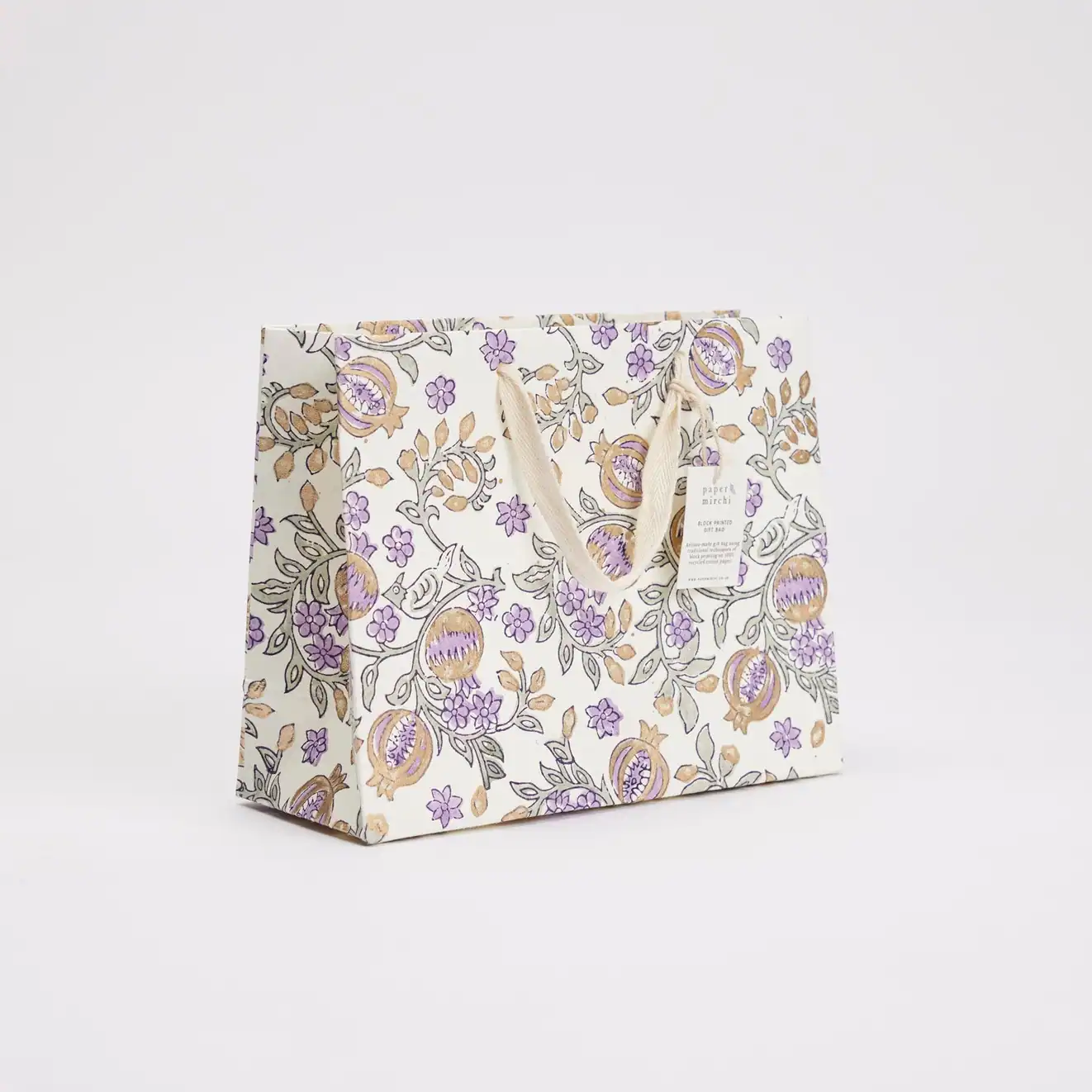 Colorful floral gift bag with elegant purple and gold accents, perfect for special occasions, crafted from high-quality paper, with sturdy cream-colored handles.