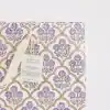 Vibrant floral block print gift bag with purple flowers and gold accents, eco-friendly and handcrafted from recycled cotton paper, perfect for artisanal gift wrapping and special occasions.