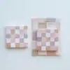 Pink and beige checkered sticky notes on white background, branded as The Wraperie.