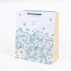 Colorful floral and bee printed gift bag with striped side panel from The Wraperie, perfect for special occasions and thoughtful gift wrapping.