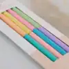 Rainbow pastel-colored pens in a gift box for creative writing or journaling.