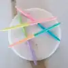 Pastel-colored pens on a white marble coaster, vibrant and trendy stationery accessories.