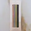 Metallic slim pens in pastel pink, gold, silver, and black, packaged in a stylish white box with 