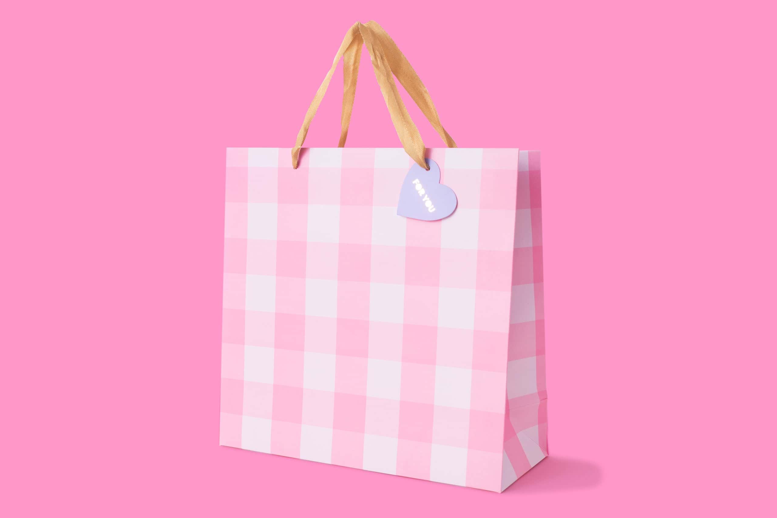 Pink checkered shopping bag with beige ribbon handles and “Thank You” heart tag - Popular gift and retail packaging from The Wraperie.