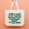 Bright white tote bag with an inspirational quote printed in bold green letters, set against a soft pink background. Perfect for casual outings, shopping, or carrying daily essentials with a positive message.