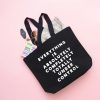 Black tote bag with motivational quote 