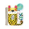 Bright yellow leopard-themed notebook with black spots, colorful leaf design, and a speech bubble reading 