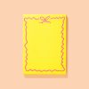 Bright yellow, pink-outlined decorative paper from The Wraperie with a whimsical, wavy border design, perfect for gift wrapping and creative packaging.