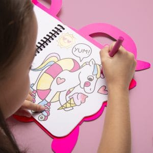Coloring activity for kids featuring a unicorn illustration on a pink heart-shaped coloring mat at The Wraperie. Perfect for children’s entertainment and creative play.