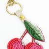 Colorful beaded cherry keychain with embroidered leaf attached, perfect for stylish accessories and gifts.