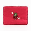 Beaded strawberry embroidered accessory on vibrant pink fabric, custom handmade, perfect for fashion and accessory lovers.
