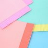 Vibrant pastel-colored paper napkins with textured edges, perfect for stylish gatherings and events. Bright colors include pink, blue, green, and yellow, ideal for adding a cheerful touch to your table setting.