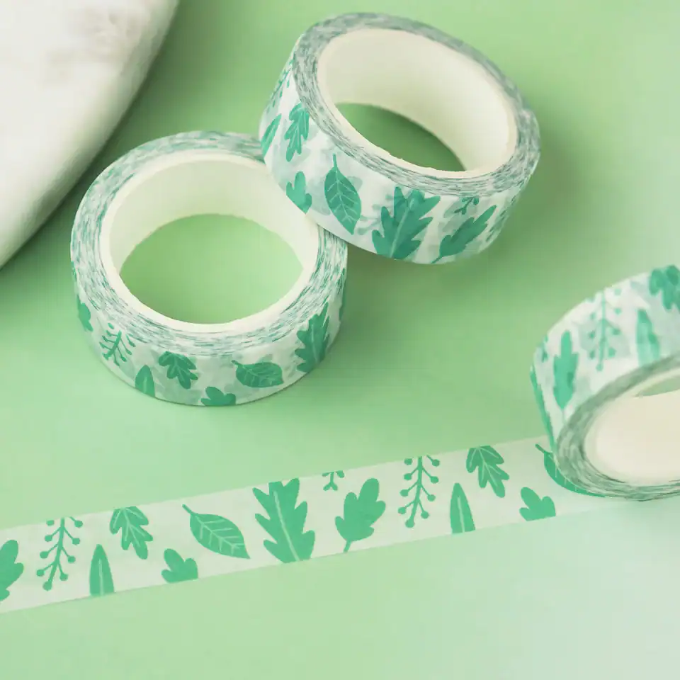Green leaf patterned washi tape for decorative and craft projects, rolls of adhesive tape with nature-inspired design, perfect for wrapping, scrapbooking, and DIY creative endeavors.