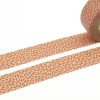 Colorful decorative washi tape featuring a pink and beige floral pattern, perfect for crafts, gift wrapping, and home decor.