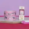 Colorful washi tape rolls with stationery designs on a desk for creative crafting and scrapbooking.