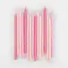 Pink birthday candles with star and dot patterns, perfect for cake decoration and celebrations.