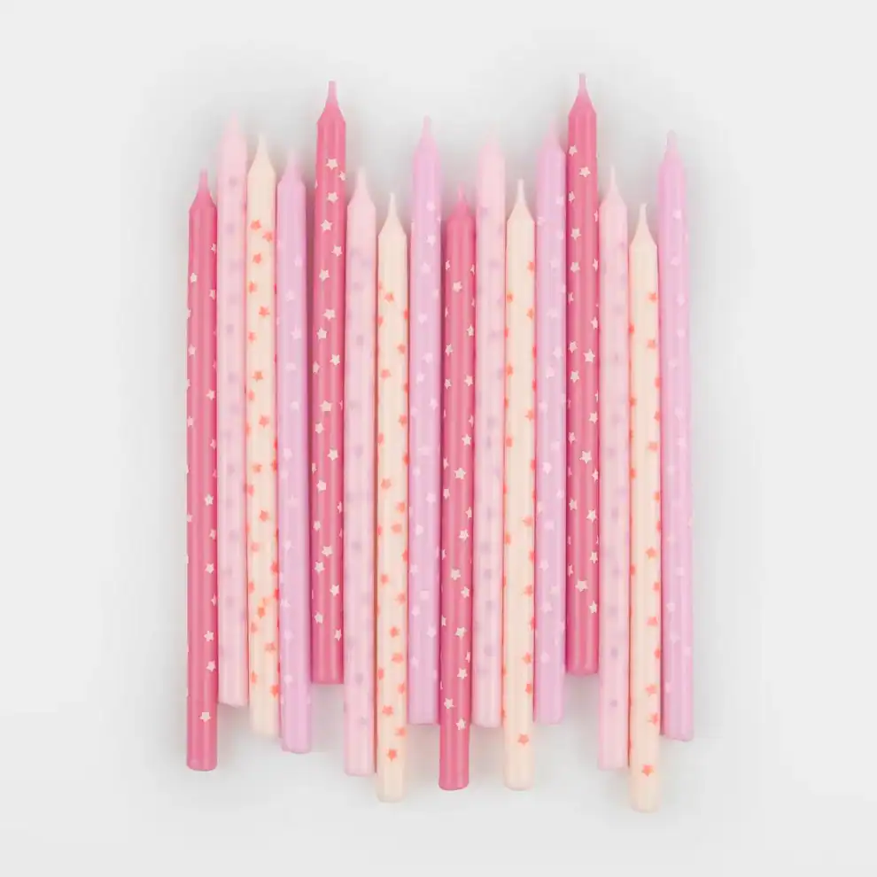 Pink birthday candles with star and dot patterns, perfect for cake decoration and celebrations.
