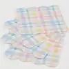Colorful pastel plaid paper wrappers for baked goods and party favors, perfect for spring or Easter celebrations. Ideal for wrapping cupcakes, candies, or small treats with a charming, festive touch.