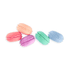 Pink, purple, green, and blue macarons arranged on a white surface with a green background.