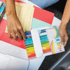 Colorful highlighters and notebooks on a desk at The Wraperie, a creative workspace, showcasing organization and office supplies ideal for personal or professional use.