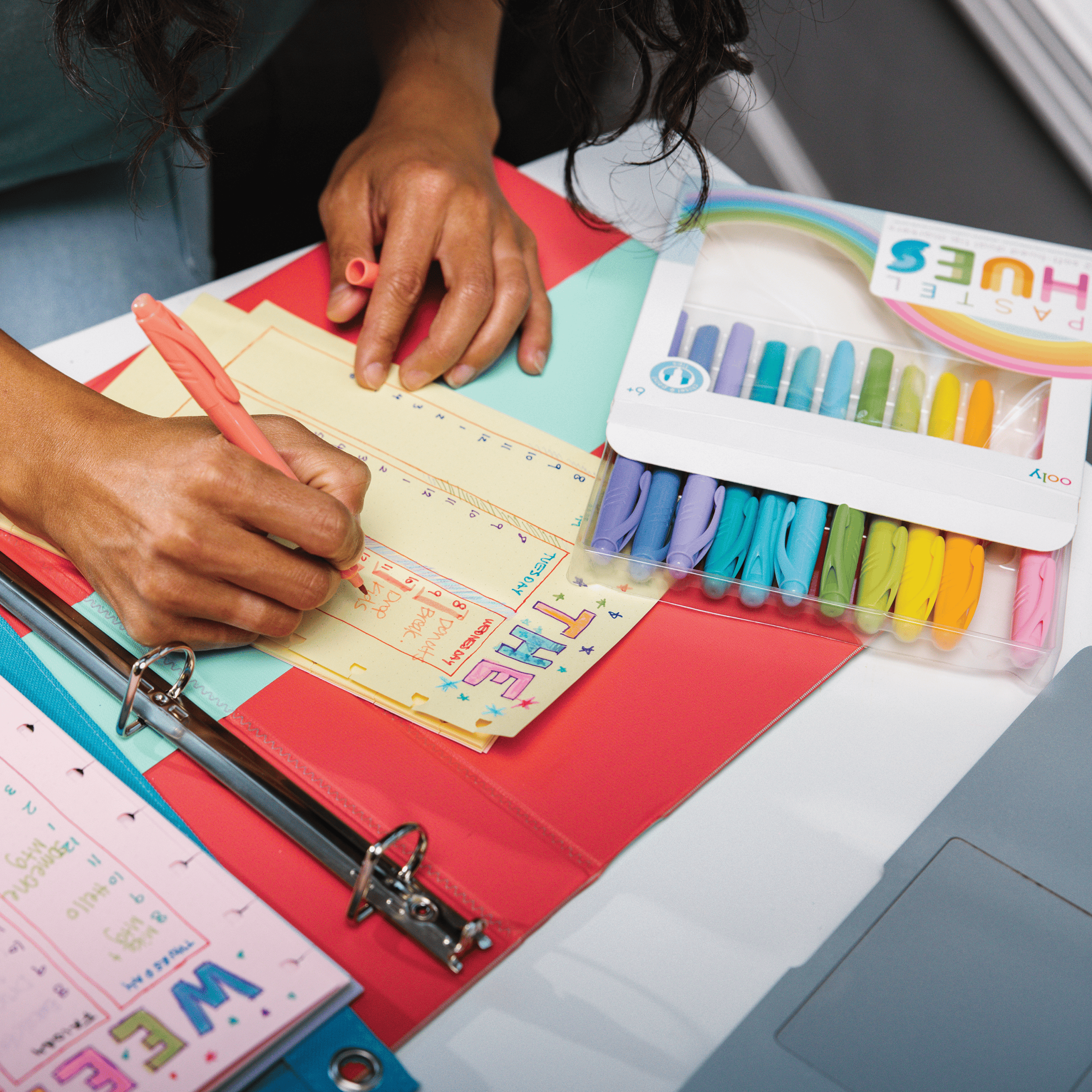 Colorful handmade greeting card with "Thank You" message and vibrant markers on a desk, showcasing craft supplies and creative design for personalized appreciation notes.
