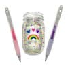 Colorful decorated glass jar with rainbow, hearts, and confetti designs, flanked by two gel pens, set against a plain white background. Perfect for craft, stationery, or gift ideas.
