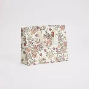 Elegant gift wrap featuring a floral and pomegranate pattern, perfect for special occasions or eco-friendly packaging at The Wraperie.